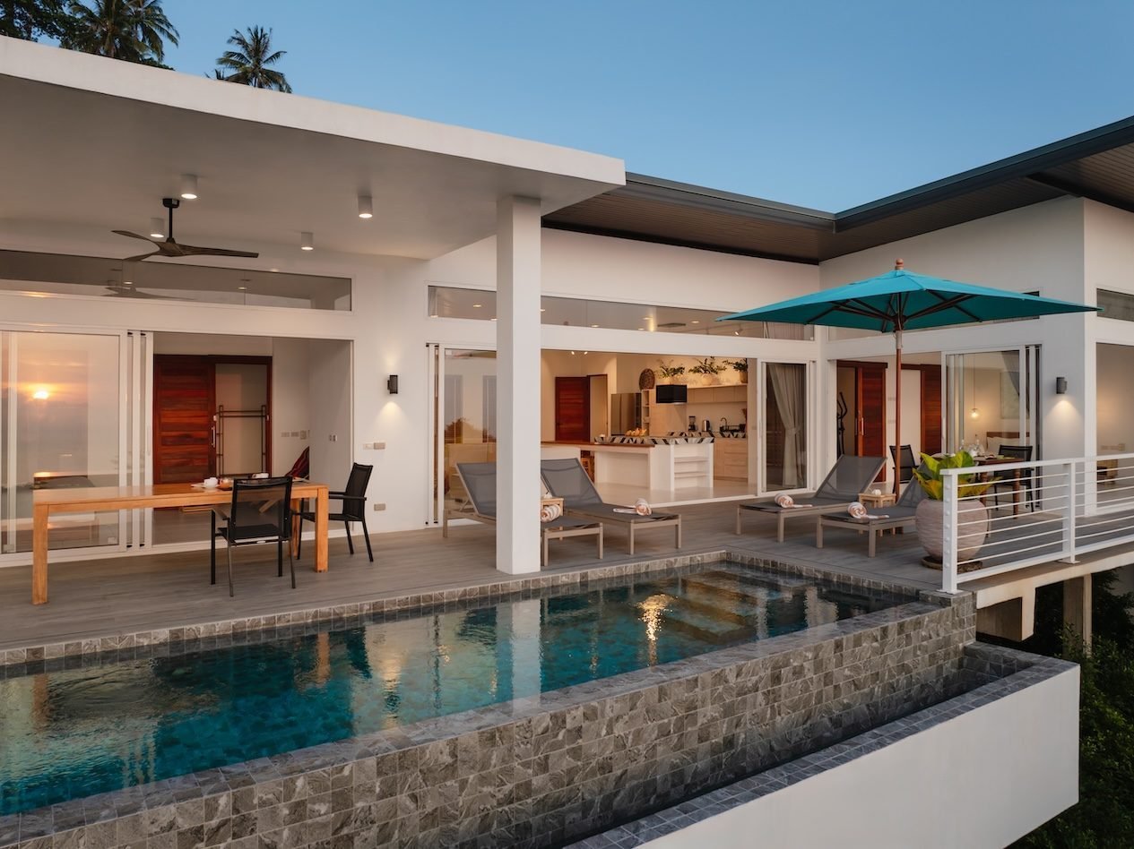 Kacha Villa exterior at sunset — pool, deck, and west-facing view